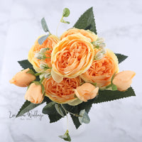 a bouquet of orange flowers on a marble table