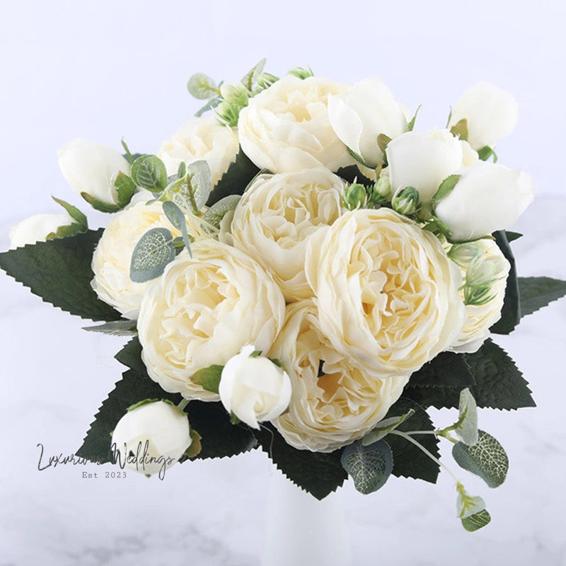 a bouquet of white flowers in a white vase