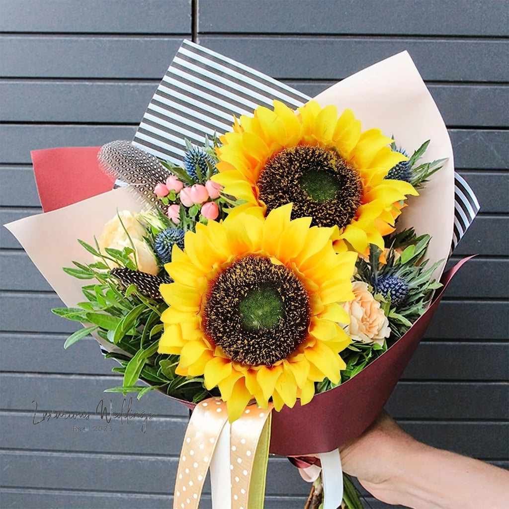 a bouquet of sunflowers in a woman's hand