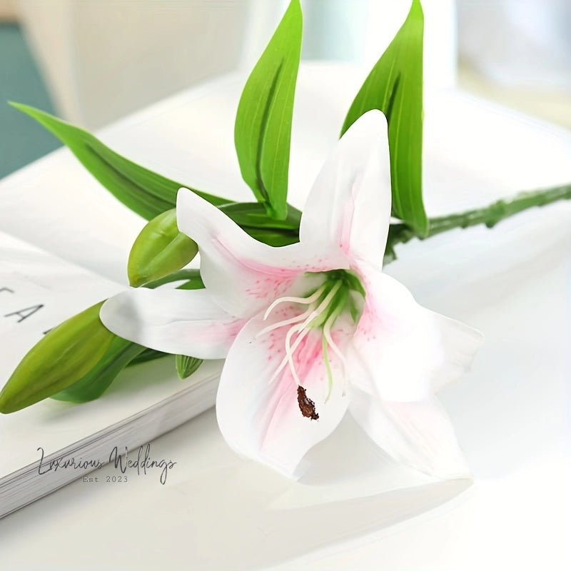 a white and pink flower sitting on top of a book