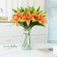 a vase filled with orange flowers on top of a table