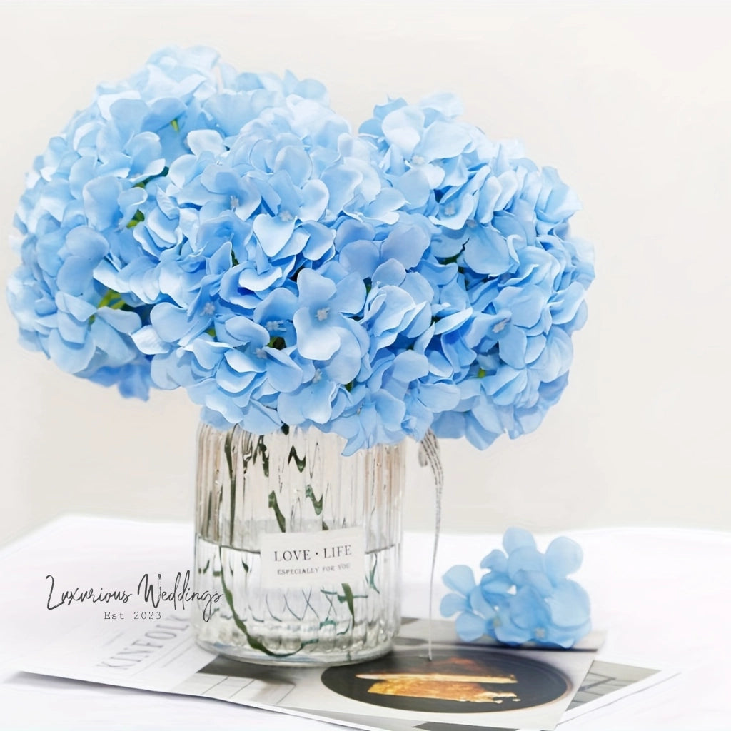 a vase filled with blue flowers on top of a table