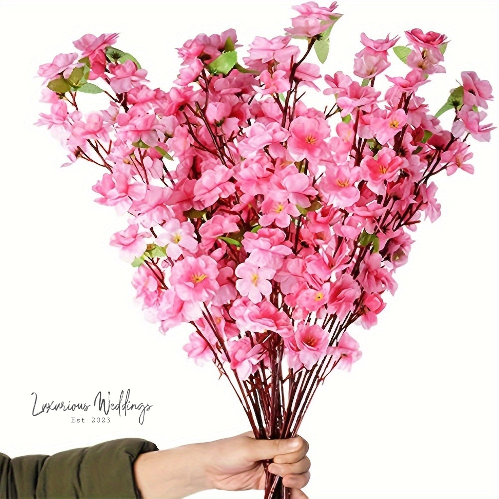 a person holding a bunch of pink flowers