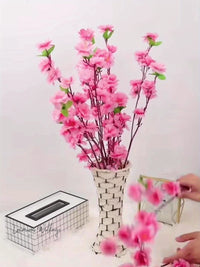 a vase with pink flowers on a table