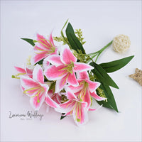 a bouquet of pink and white flowers on a white surface