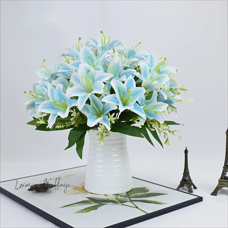 a white vase filled with blue flowers next to the eiffel tower