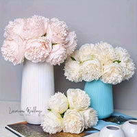 a couple of vases filled with flowers on top of a table