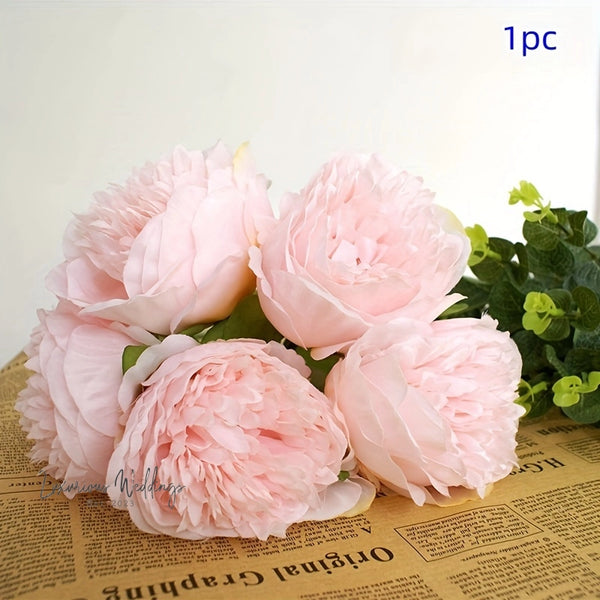 a bunch of pink flowers sitting on top of a newspaper