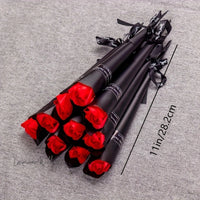 a bunch of black and red roses on a table