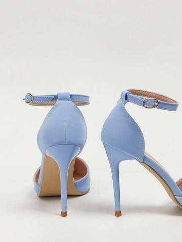 a pair of blue high heeled shoes on a white background