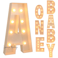 a light up letter that says baby