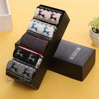 six pairs of socks in a box on a table