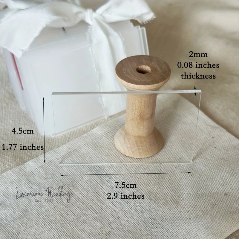 a wooden spool of thread sitting on top of a piece of cloth