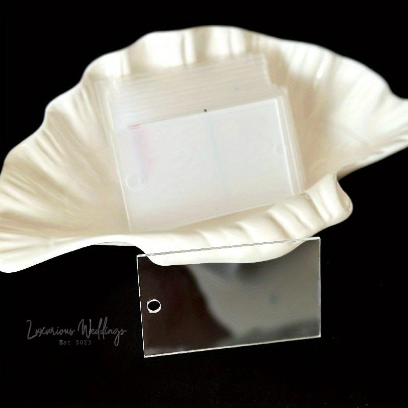 a white shell shaped object with a clear square in the middle