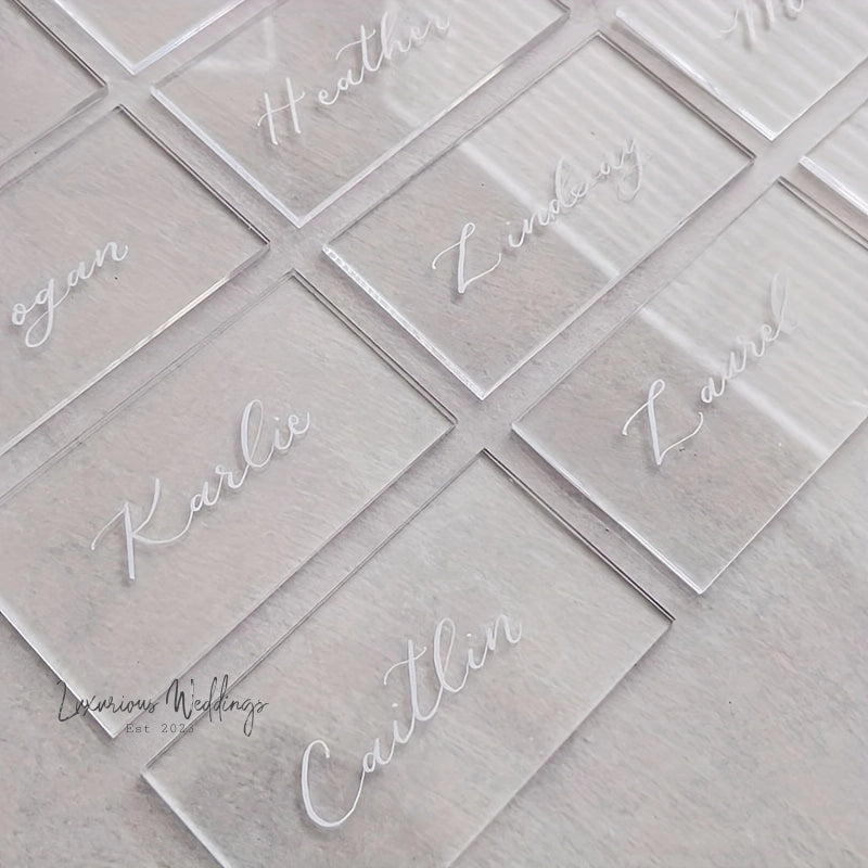 clear acrylic business cards with white writing on them
