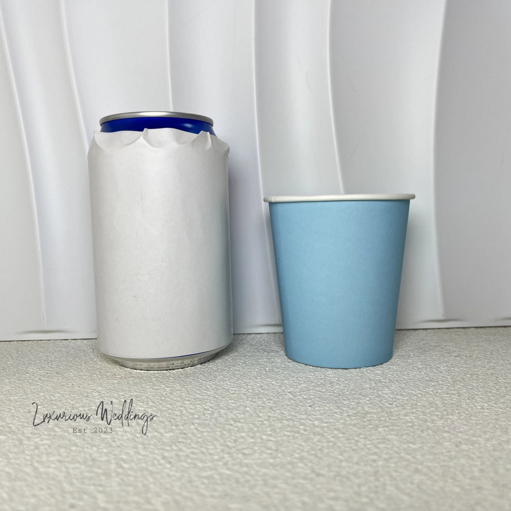 a blue cup next to a white container