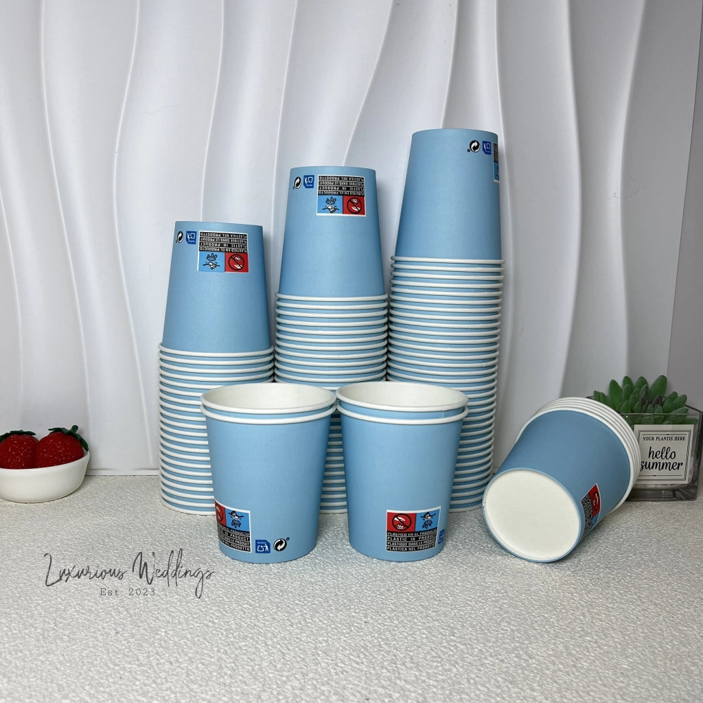 a stack of blue cups sitting on top of a table
