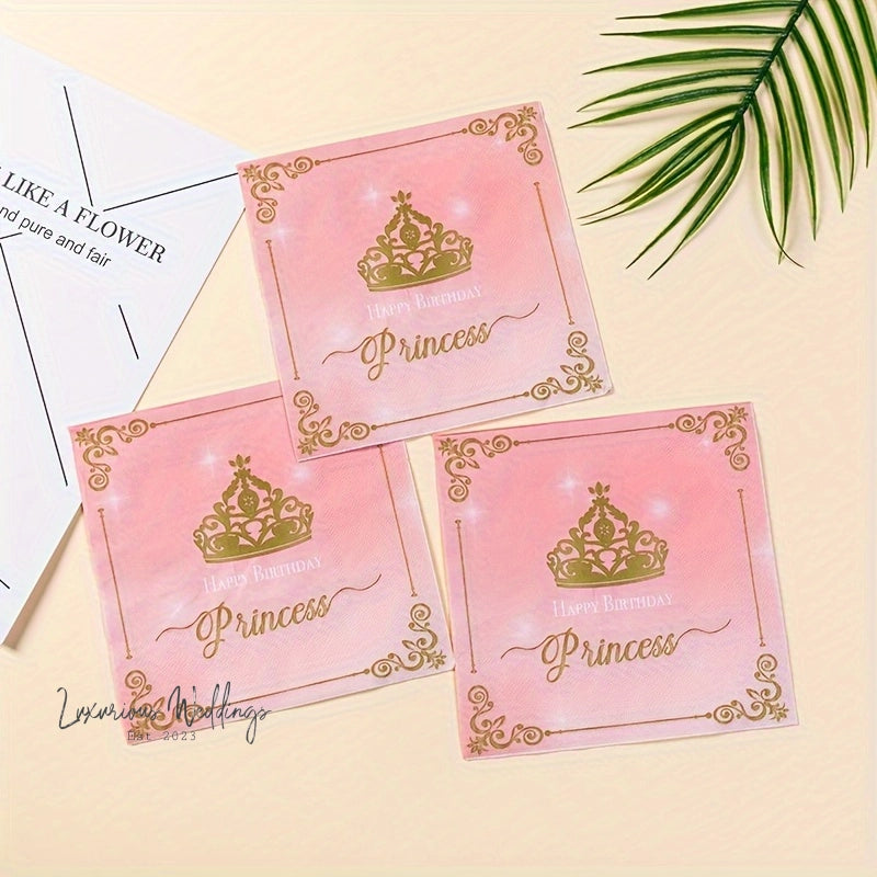 three pink princess place cards with gold crowns on them