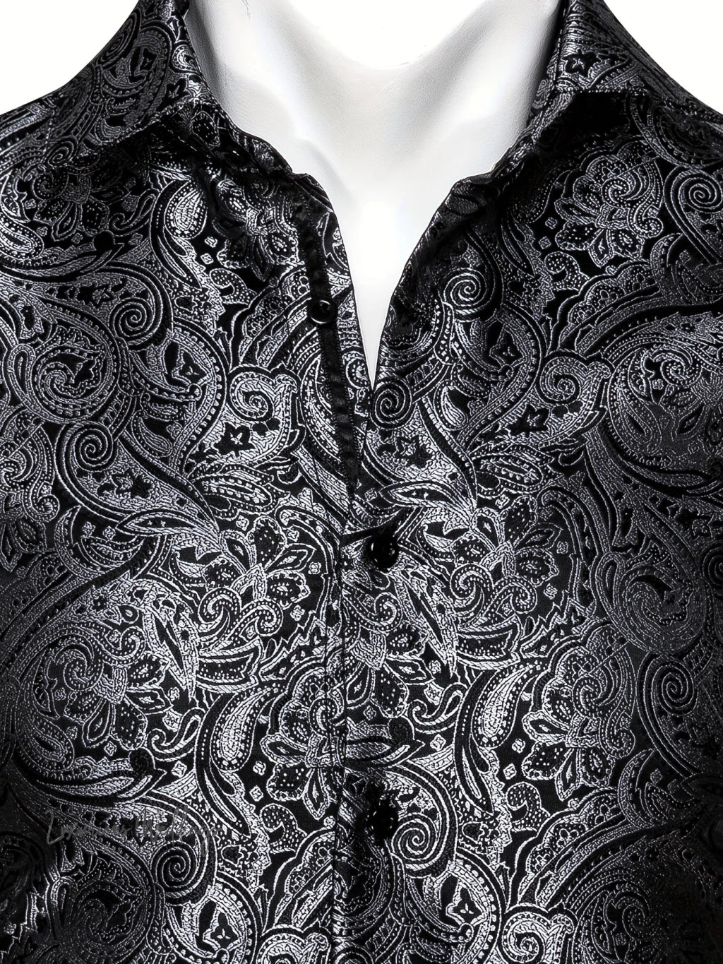 a man wearing a black shirt with a paisley pattern