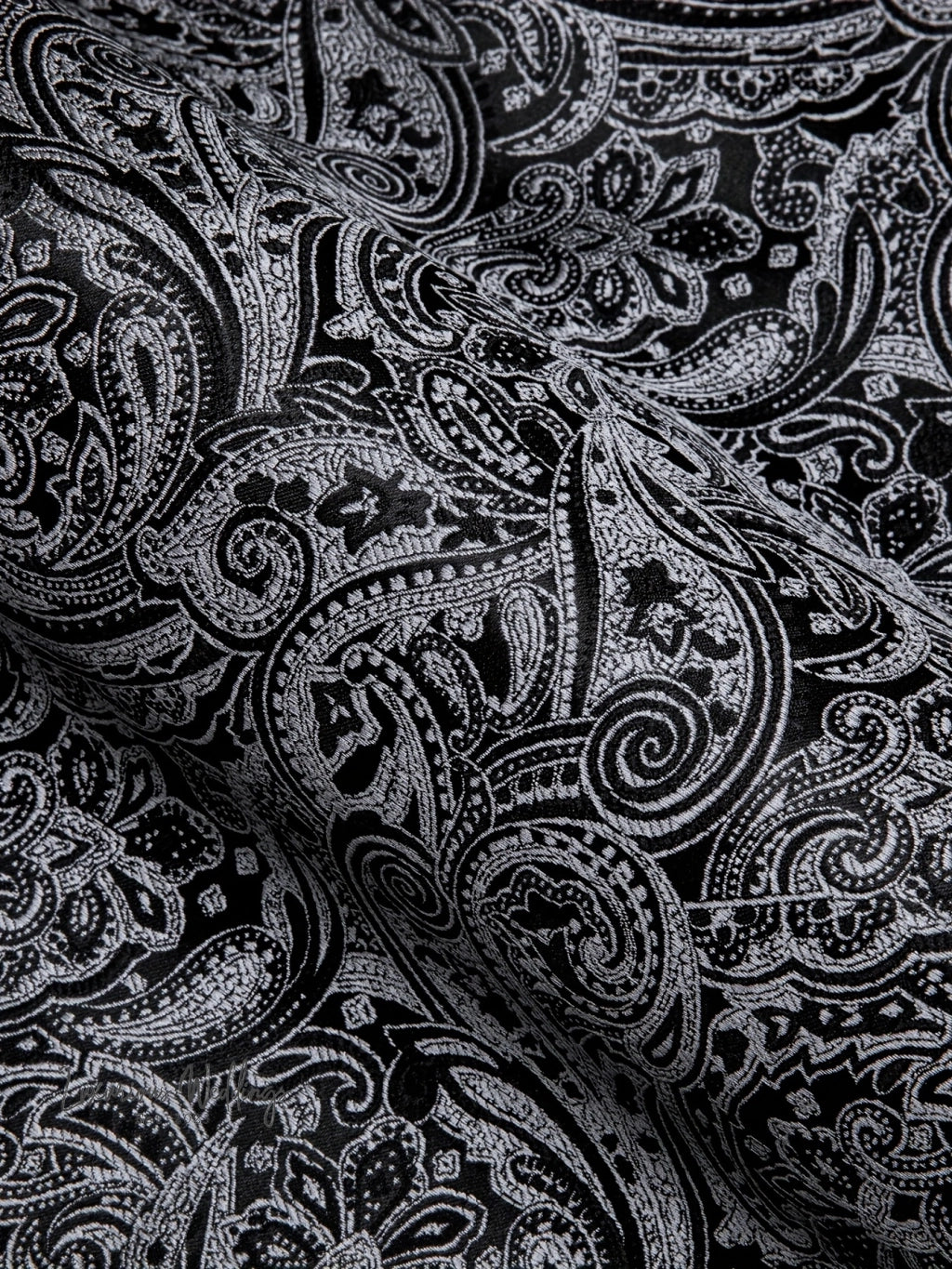 a close up of a black and white paisley print fabric