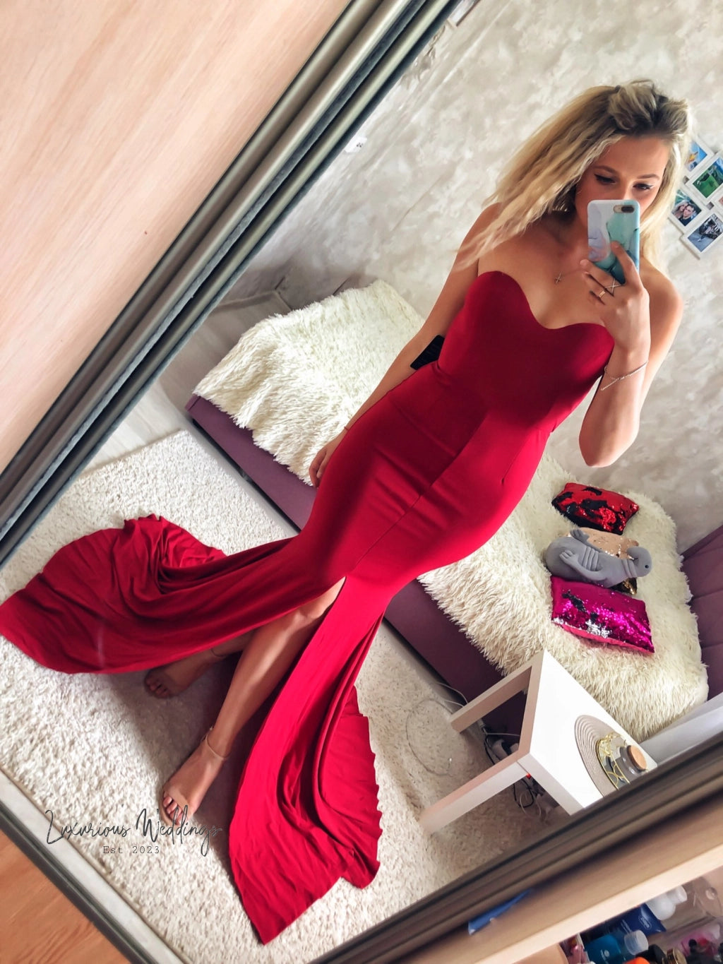 a woman in a red dress taking a selfie
