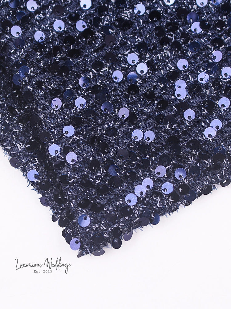 a close up of a black and blue sequins