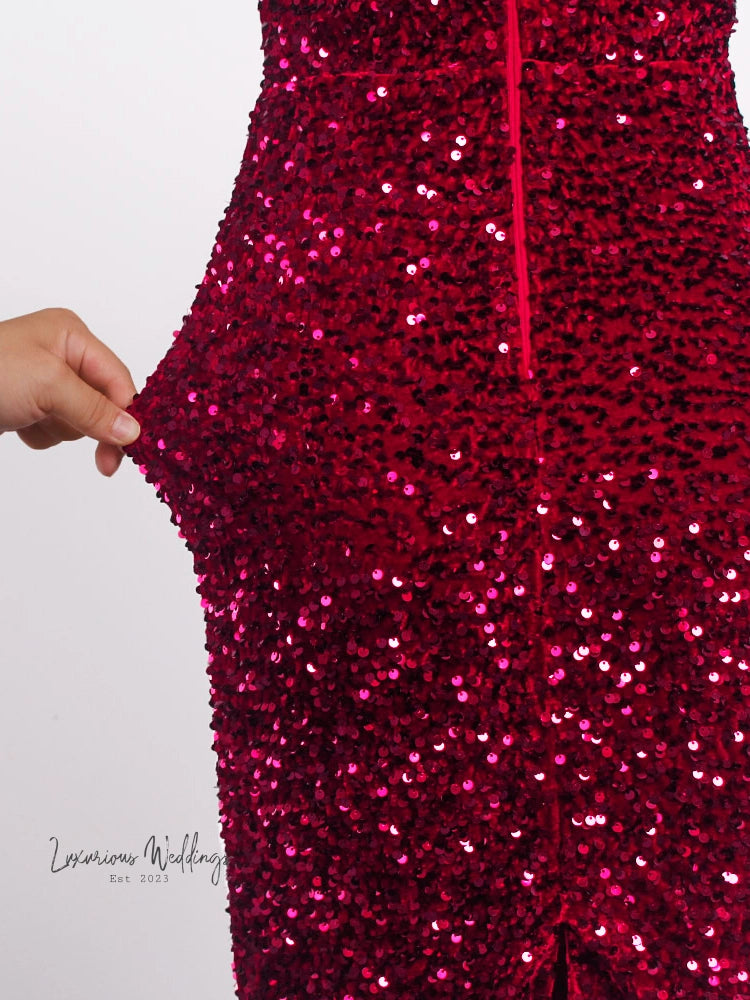 a close up of a person wearing a red sequin dress