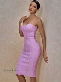 a woman in a purple dress posing for a picture
