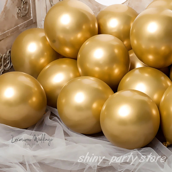 a pile of shiny gold balloons sitting on top of a table