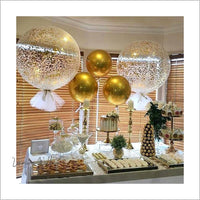 a table topped with lots of balloons and desserts