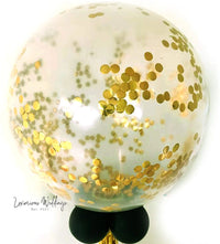 a white ball with gold confetti on it