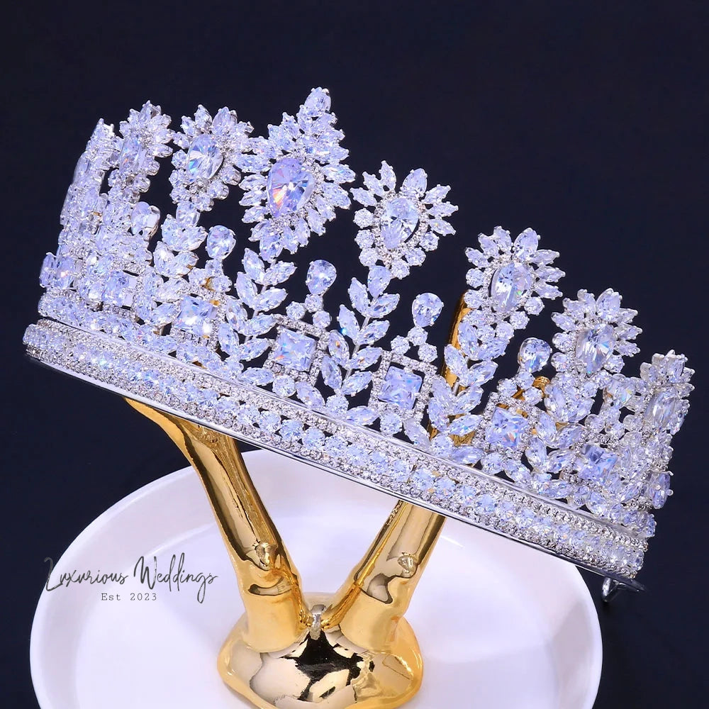 a white plate topped with a gold and crystal tiara