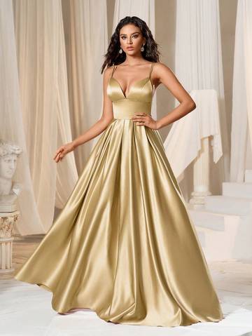 a woman in a gold gown posing for a picture