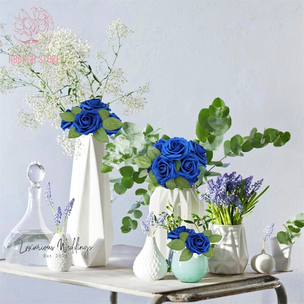 a table topped with vases filled with blue flowers