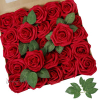 a box of red roses with green leaves