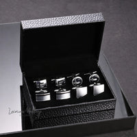 a set of four cufflinkes in a black box