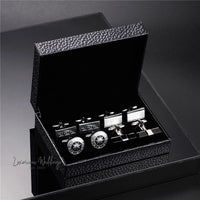 a black box with three cufflinks in it