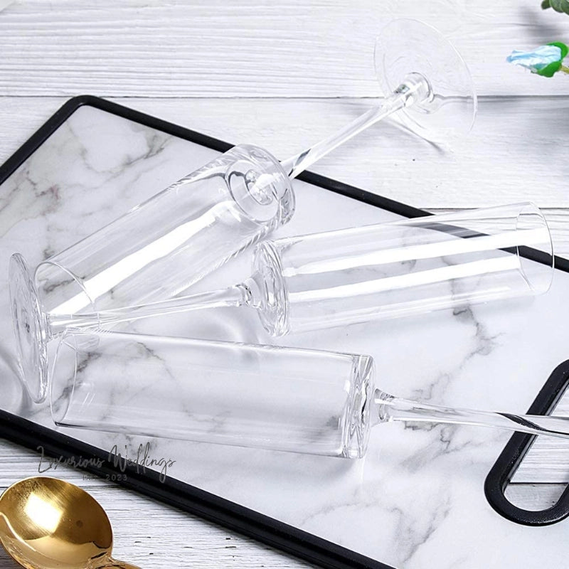 a glass serving tray with a gold spoon on it