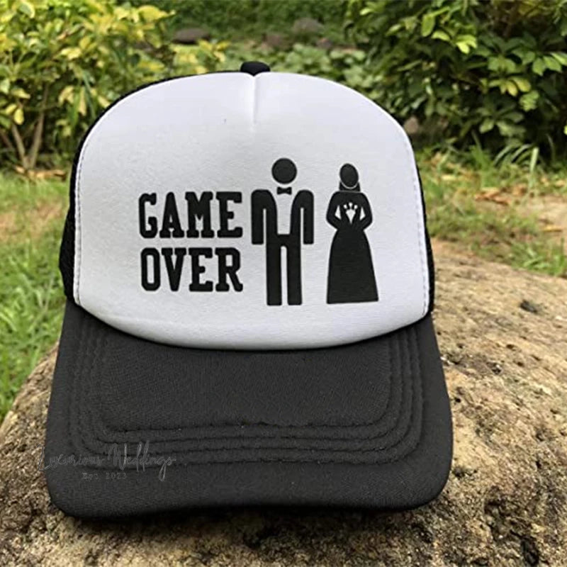 a black and white trucker hat that says game over