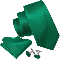 a green tie, cufflinks and a pair of cufflinks