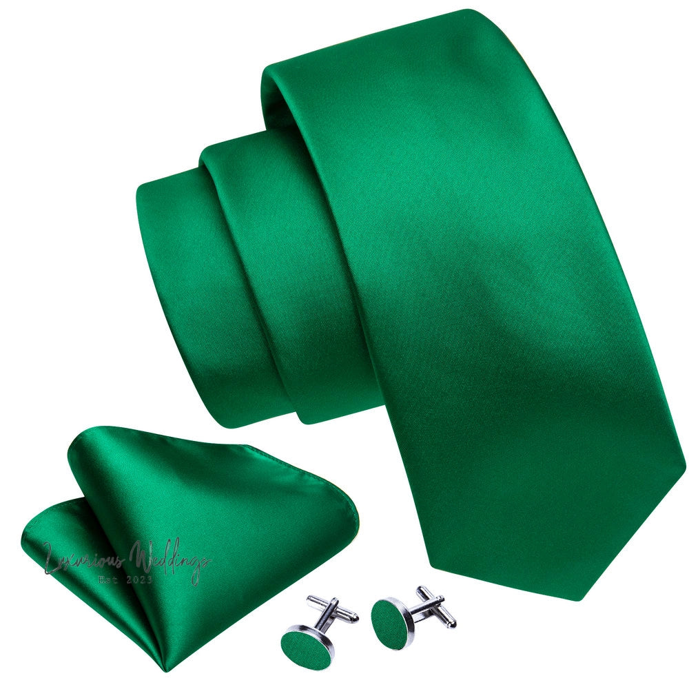 a green tie, cufflinks and a pair of earrings