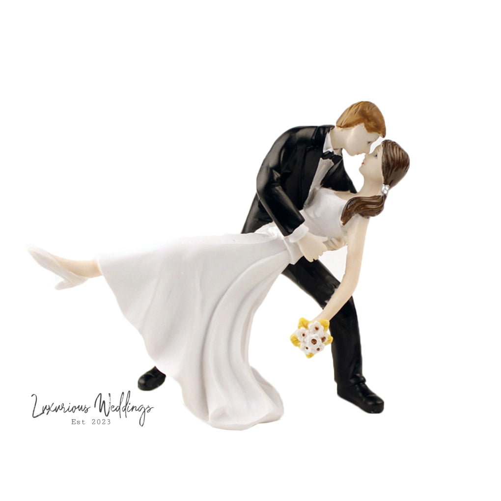 a wedding cake topper of a bride and groom