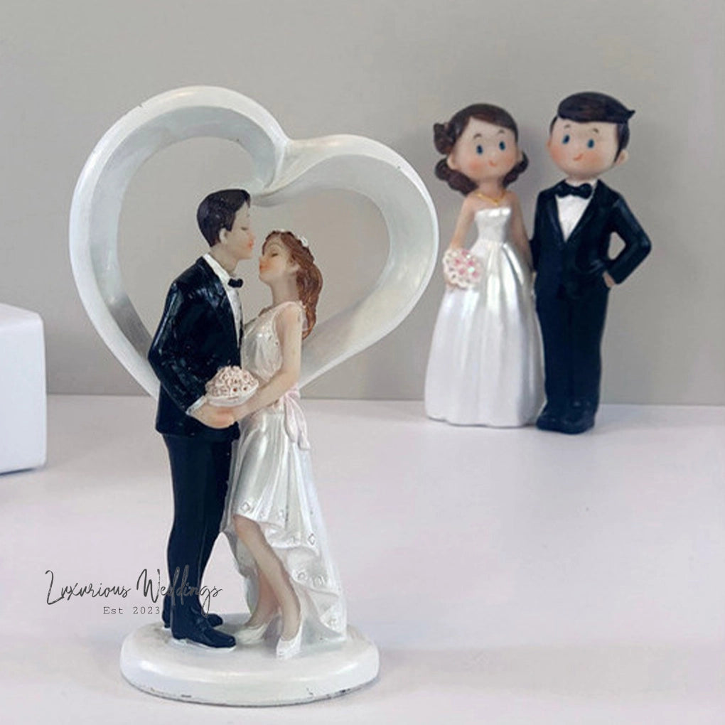 a cake topper of a bride and groom kissing