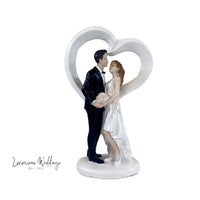 a figurine of a bride and groom holding each other
