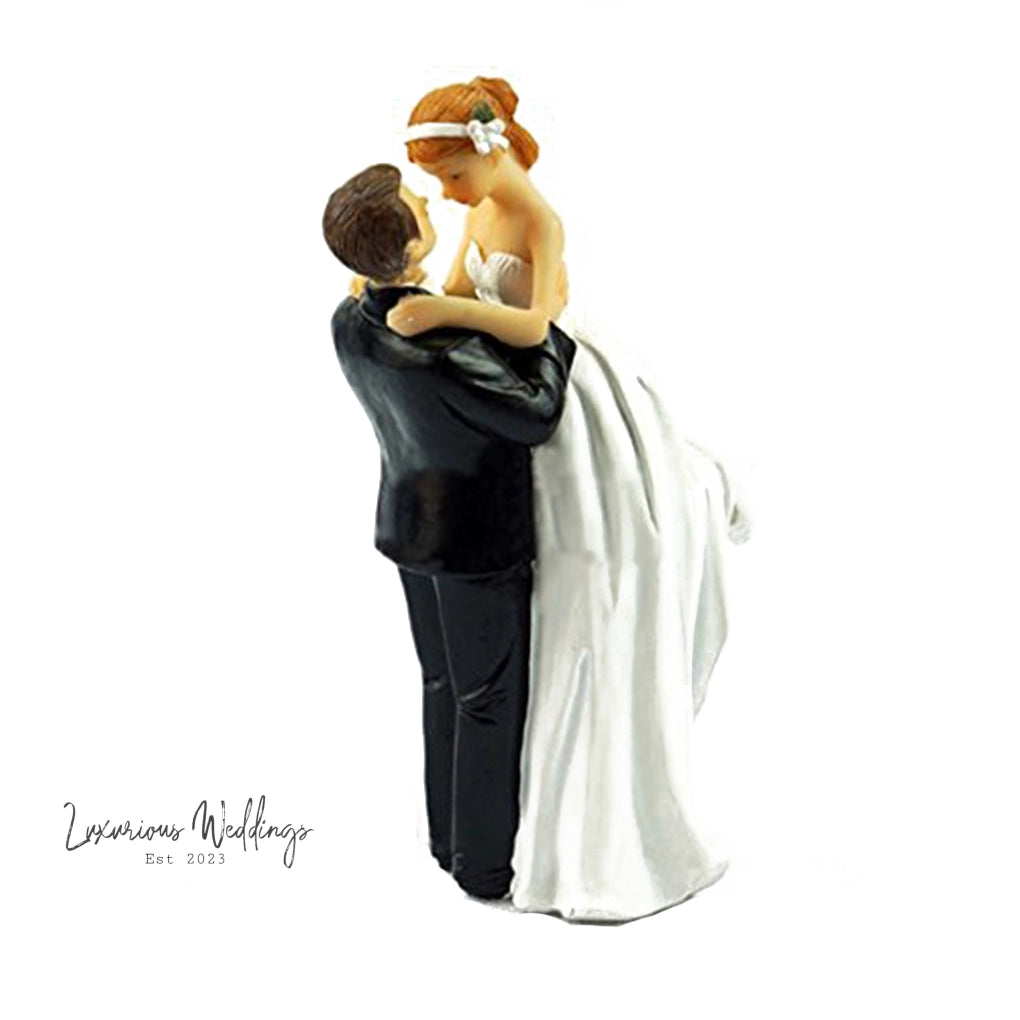 a figurine of a bride and groom holding each other