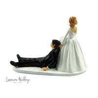 a figurine of a bride and groom laying down