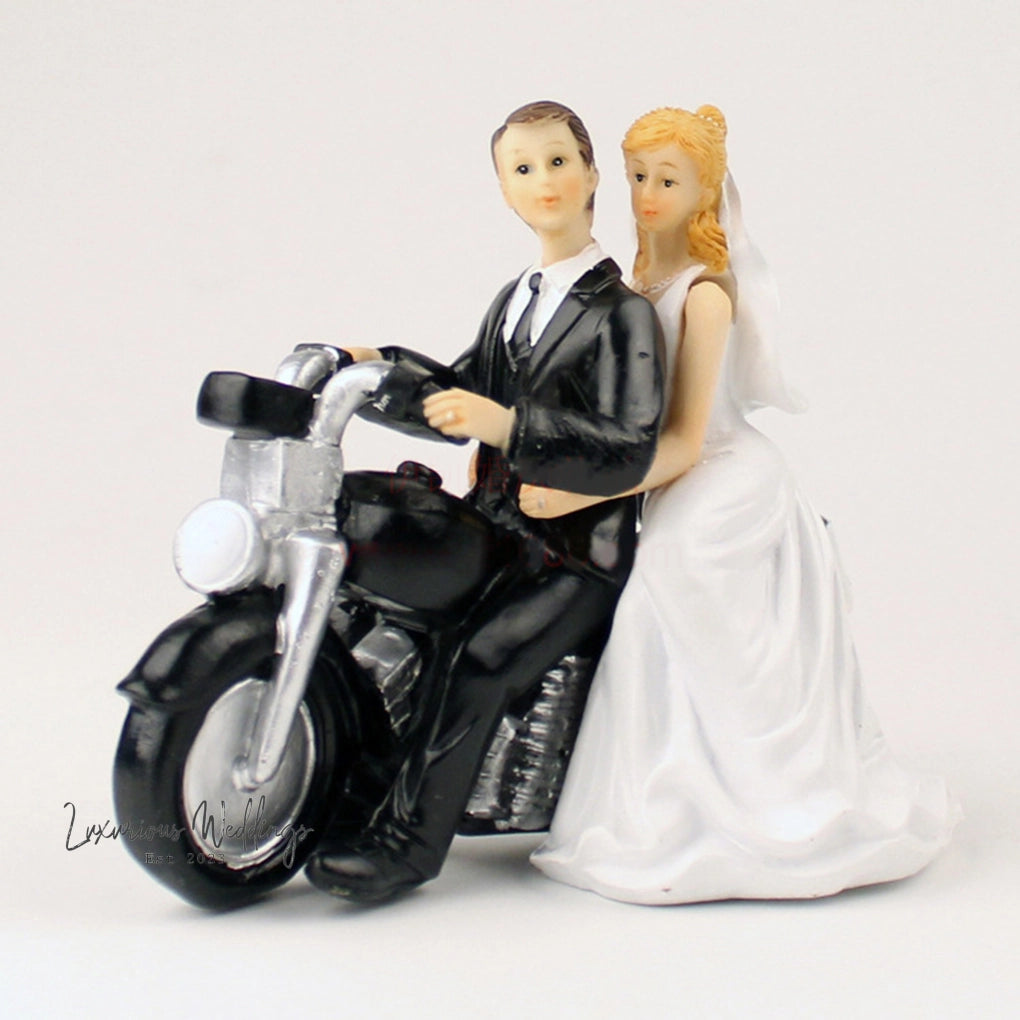 a figurine of a bride and groom on a motorcycle