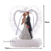 a wedding cake topper with a bride and groom
