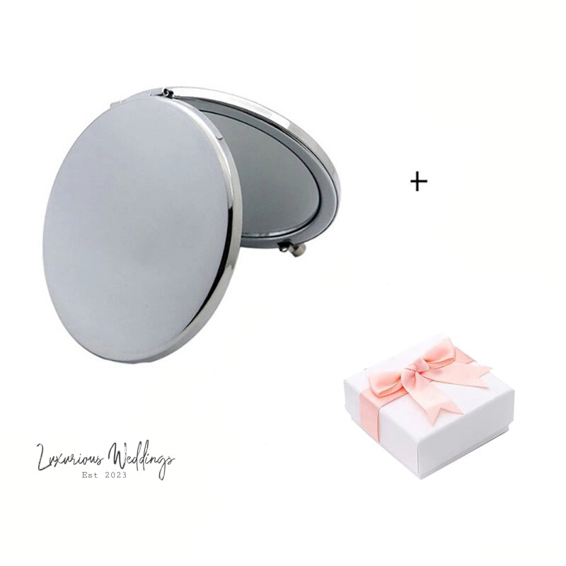 a white box with a pink bow and a mirror