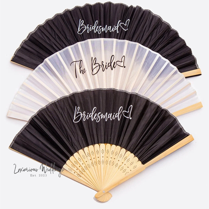 a black and white fan with the names of the bride and groom